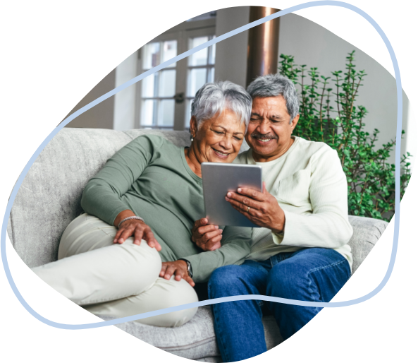 A husband showing his health results on a tablet to his wife
