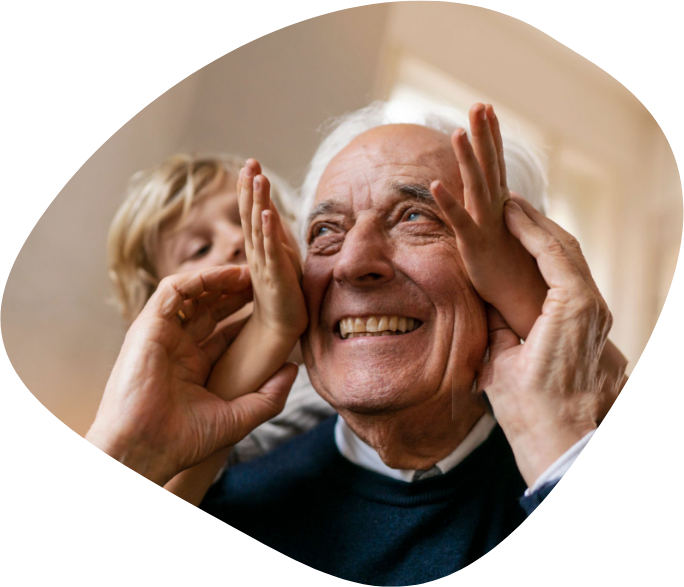A man and his grandson holding their hands up